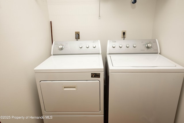 clothes washing area with washer and clothes dryer