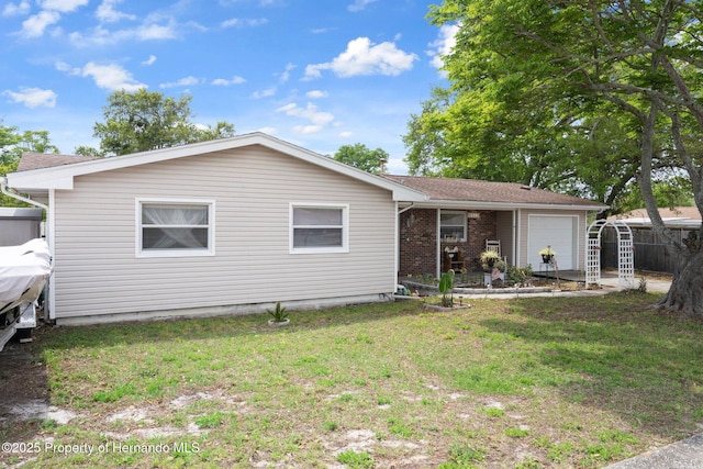 9414 Northcliffe Blvd, Spring Hill, FL 34606 - view of front of property featuring a front lawn, fence, and an attached garage