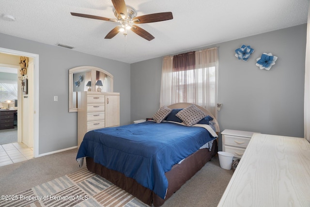 9414 Northcliffe Blvd, Spring Hill, FL 34606 - bedroom with visible vents, baseboards, ceiling fan, a textured ceiling, and carpet flooring