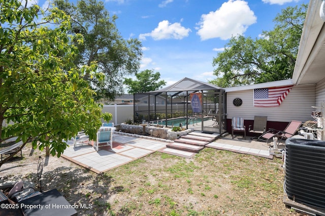 9414 Northcliffe Blvd, Spring Hill, FL 34606 - view of yard with central air condition unit, glass enclosure, a patio area, fence, and a fenced in pool