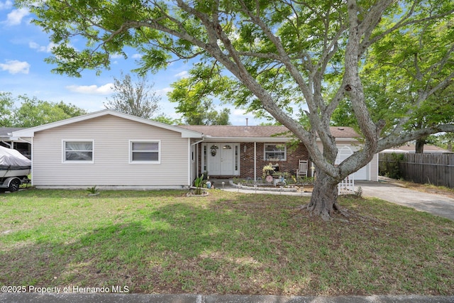 9414 Northcliffe Blvd, Spring Hill, FL 34606 - ranch-style home featuring concrete driveway, a front yard, and fence