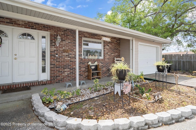 9414 Northcliffe Blvd, Spring Hill, FL 34606 - property entrance featuring brick siding, an attached garage, fence, and driveway
