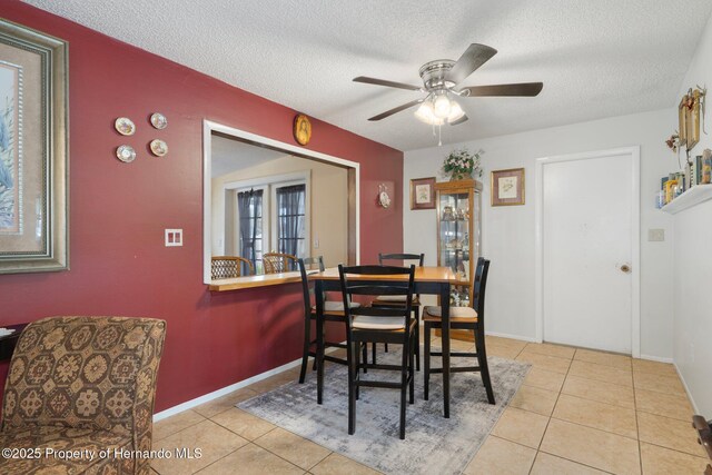 9414 Northcliffe Blvd, Spring Hill, FL 34606 - tiled dining area featuring ceiling fan, baseboards, and a textured ceiling