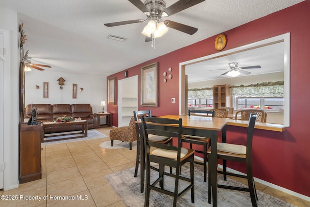 9414 Northcliffe Blvd, Spring Hill, FL 34606 - tiled dining room featuring visible vents, a textured ceiling, and ceiling fan