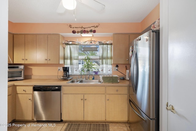 9414 Northcliffe Blvd, Spring Hill, FL 34606 - kitchen with stainless steel appliances, light brown cabinets, light countertops, and a sink