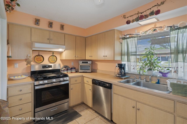 9414 Northcliffe Blvd, Spring Hill, FL 34606 - kitchen with light countertops, under cabinet range hood, stainless steel appliances, a sink, and light brown cabinetry