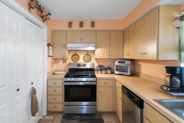 9414 Northcliffe Blvd, Spring Hill, FL 34606 - kitchen with stainless steel appliances, under cabinet range hood, light brown cabinets, and light countertops