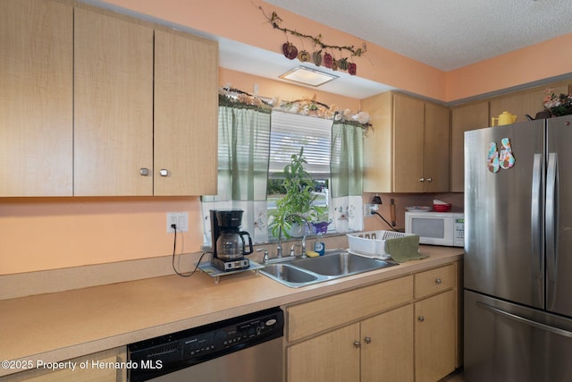 9414 Northcliffe Blvd, Spring Hill, FL 34606 - kitchen featuring a sink, light countertops, light brown cabinetry, a textured ceiling, and stainless steel appliances