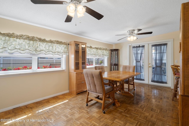 9414 Northcliffe Blvd, Spring Hill, FL 34606 - dining room with baseboards, a textured ceiling, and a ceiling fan