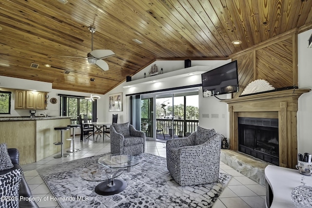 living area featuring wooden ceiling, light tile patterned flooring, lofted ceiling, and a fireplace with raised hearth