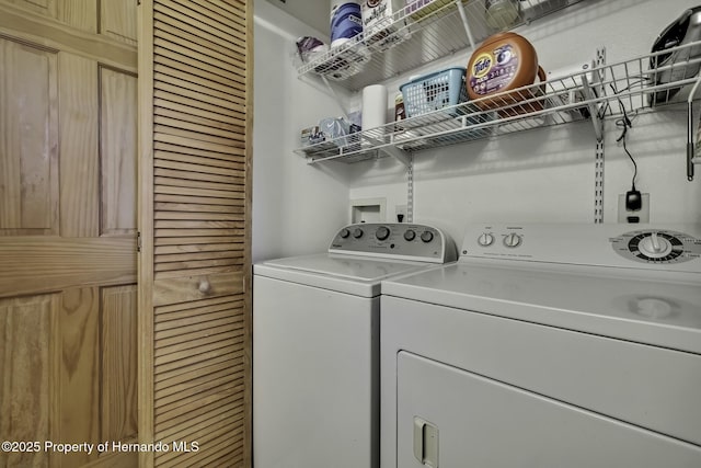 washroom featuring independent washer and dryer and laundry area