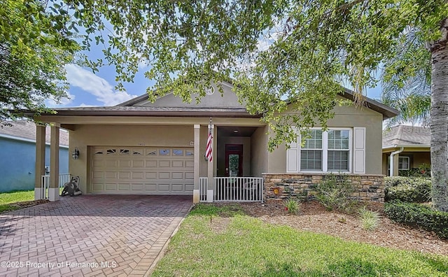 5401 Cappleman Loop, Brooksville, FL 34601 - ranch-style home with stucco siding, a garage, stone siding, and decorative driveway