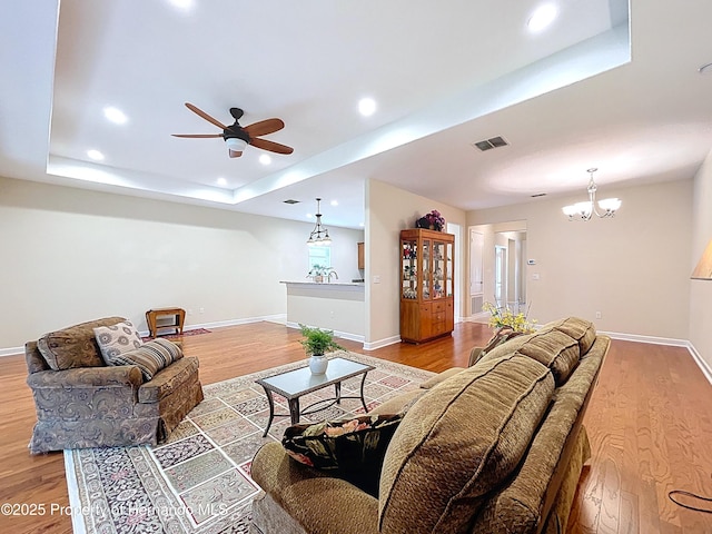 5401 Cappleman Loop, Brooksville, FL 34601 - living room featuring a raised ceiling, wood finished floors, a ceiling fan, recessed lighting, and baseboards