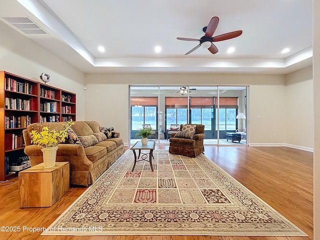 5401 Cappleman Loop, Brooksville, FL 34601 - living room with a ceiling fan, wood finished floors, a raised ceiling, and recessed lighting
