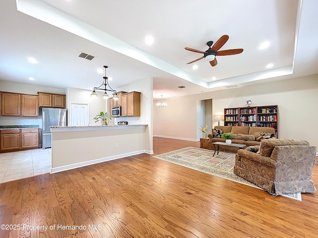 5401 Cappleman Loop, Brooksville, FL 34601 - living area featuring ceiling fan, light wood-type flooring, baseboards, recessed lighting, and a chandelier