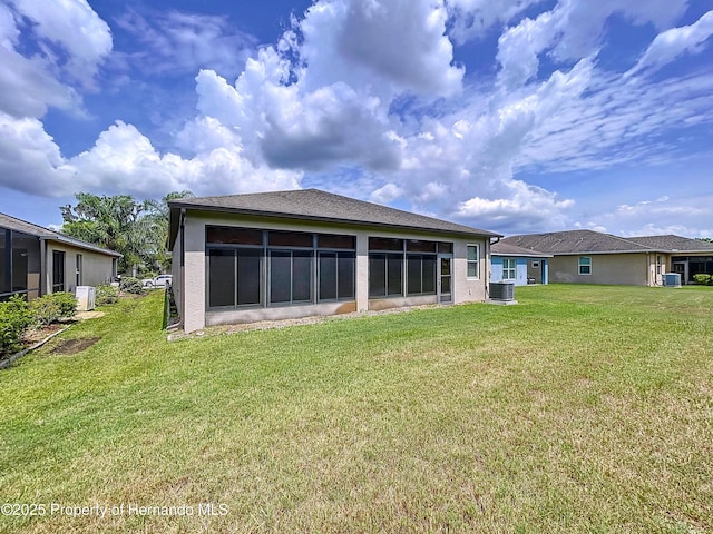 5401 Cappleman Loop, Brooksville, FL 34601 - back of property with cooling unit, a lawn, stucco siding, and a sunroom