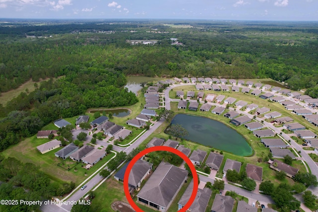 5401 Cappleman Loop, Brooksville, FL 34601 - aerial view of property and surrounding area featuring a forest, nearby suburban area, and a nearby body of water