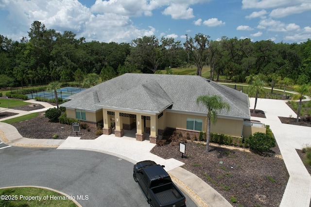 5401 Cappleman Loop, Brooksville, FL 34601 - view of front of property with curved driveway and a shingled roof