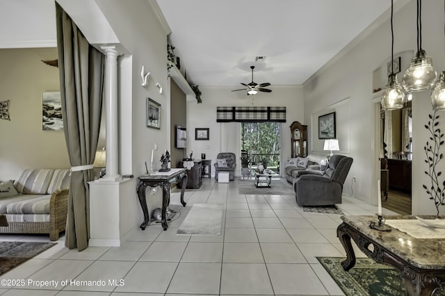 10109 Holly Berry Dr, Weeki Wachee, FL 34613 - living room featuring crown molding, decorative columns, ceiling fan, and tile patterned flooring
