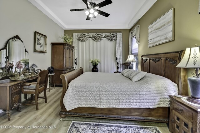 10109 Holly Berry Dr, Weeki Wachee, FL 34613 - bedroom featuring ceiling fan and light wood finished floors