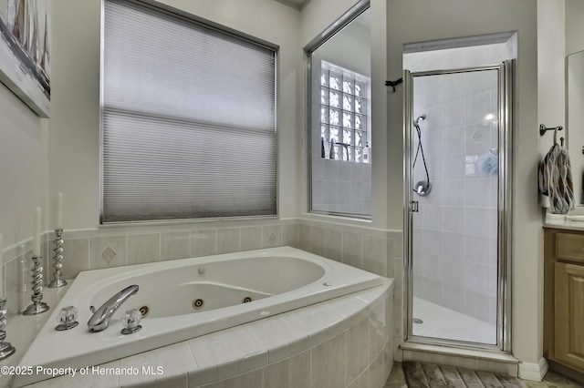 10109 Holly Berry Dr, Weeki Wachee, FL 34613 - full bathroom with a shower stall, vanity, and a whirlpool tub