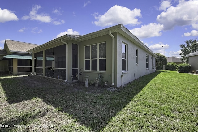 10109 Holly Berry Dr, Weeki Wachee, FL 34613 - view of home's exterior featuring a sunroom, a lawn, and stucco siding