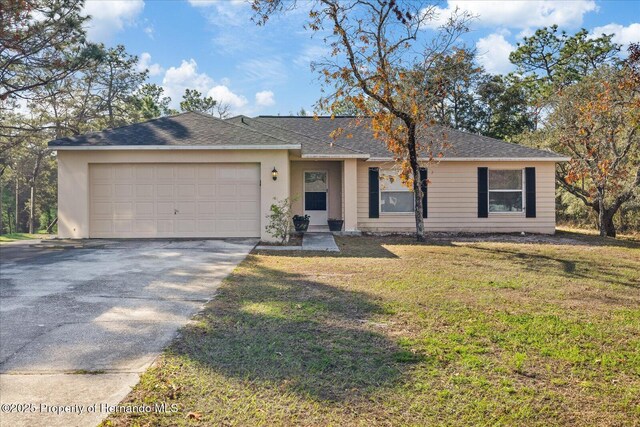 12575 Maleo Rd, Weeki Wachee, FL 34614 - single story home with concrete driveway, an attached garage, a front lawn, roof with shingles, and stucco siding