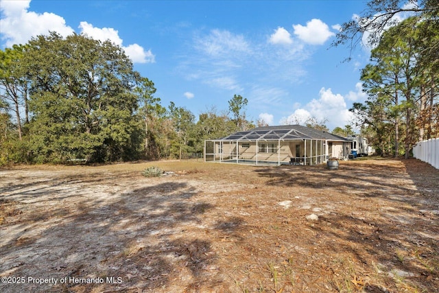 12575 Maleo Rd, Weeki Wachee, FL 34614 - rear view of house with glass enclosure and fence