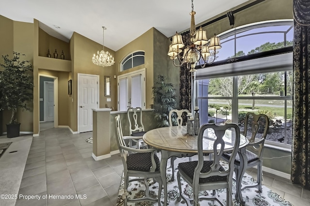 17364 Mediterranean Cir, Brooksville, FL 34614 - tiled dining area with high vaulted ceiling, an inviting chandelier, and baseboards