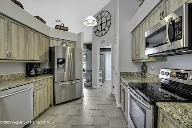 17364 Mediterranean Cir, Brooksville, FL 34614 - kitchen featuring visible vents, a high ceiling, light tile patterned flooring, and appliances with stainless steel finishes