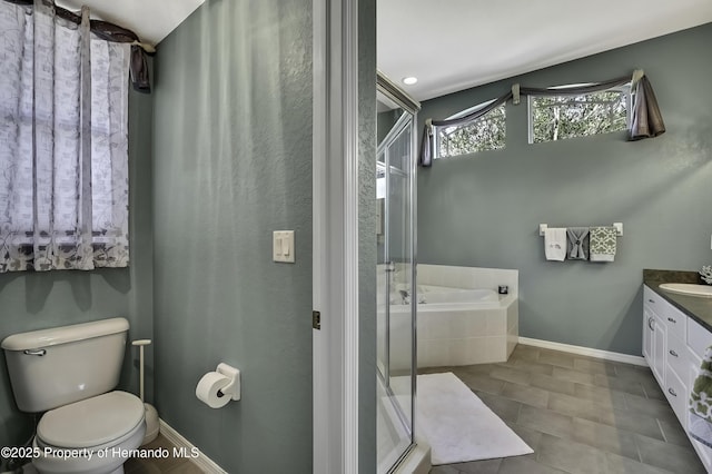 17364 Mediterranean Cir, Brooksville, FL 34614 - bathroom featuring vanity, baseboards, a stall shower, toilet, and a garden tub