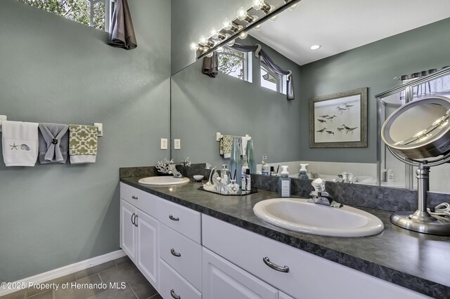 17364 Mediterranean Cir, Brooksville, FL 34614 - full bath featuring tile patterned floors, double vanity, a sink, and baseboards