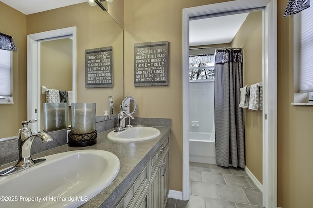 17364 Mediterranean Cir, Brooksville, FL 34614 - bathroom featuring shower / bathtub combination with curtain, double vanity, a sink, and baseboards