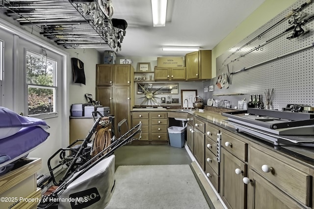 17364 Mediterranean Cir, Brooksville, FL 34614 - kitchen with concrete floors, open shelves, brown cabinetry, a sink, and stovetop