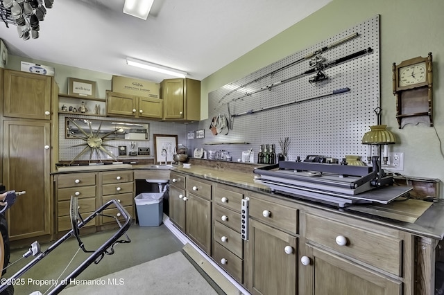 17364 Mediterranean Cir, Brooksville, FL 34614 - kitchen with a sink, dark countertops, open shelves, and finished concrete flooring