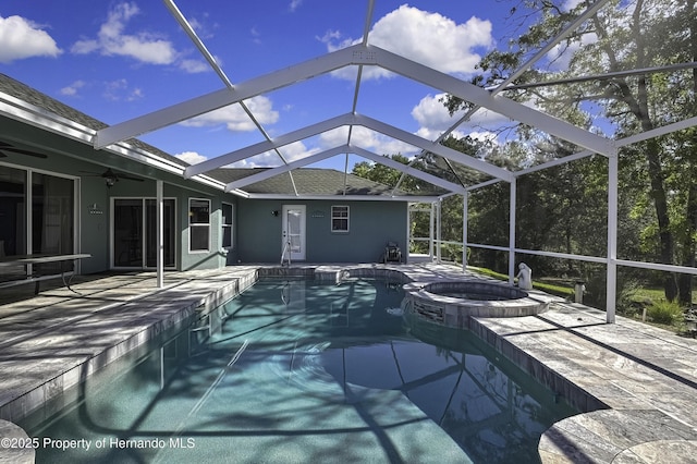 17364 Mediterranean Cir, Brooksville, FL 34614 - view of swimming pool featuring ceiling fan, a patio area, a pool with connected hot tub, and glass enclosure