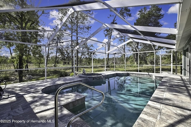 17364 Mediterranean Cir, Brooksville, FL 34614 - view of pool featuring a lanai, a patio area, and a pool with connected hot tub