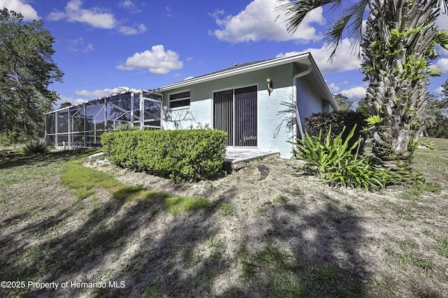 17364 Mediterranean Cir, Brooksville, FL 34614 - rear view of property with a lanai and stucco siding