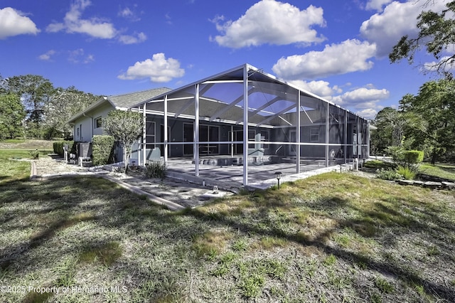 17364 Mediterranean Cir, Brooksville, FL 34614 - rear view of property with a patio area and glass enclosure