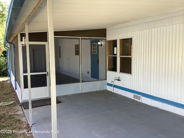 view of patio featuring a sunroom and visible vents