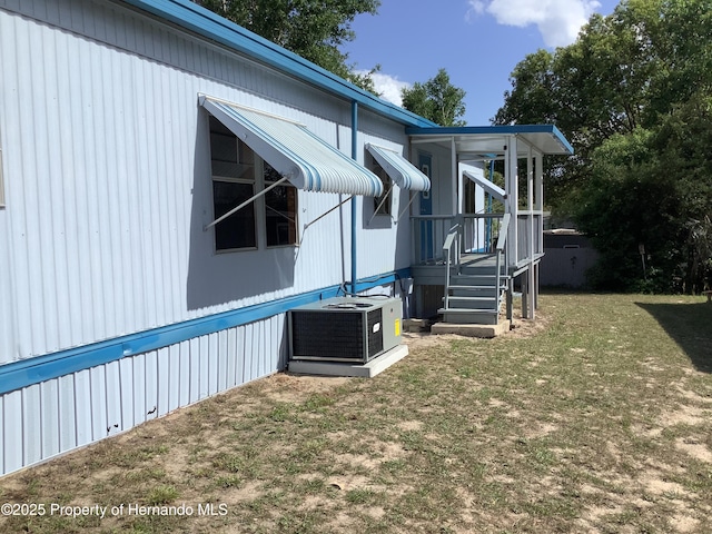 view of home's exterior featuring a yard and cooling unit