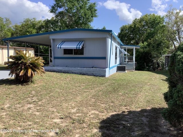 view of home's exterior featuring a yard and an attached carport