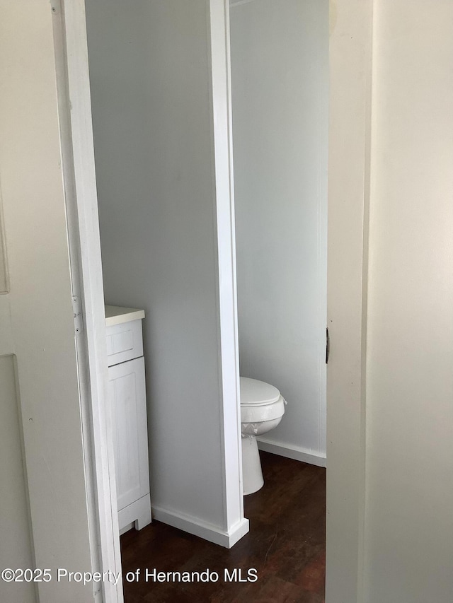 bathroom featuring baseboards and toilet