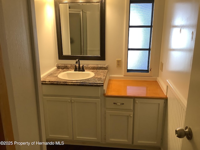 full bathroom featuring an enclosed shower and vanity