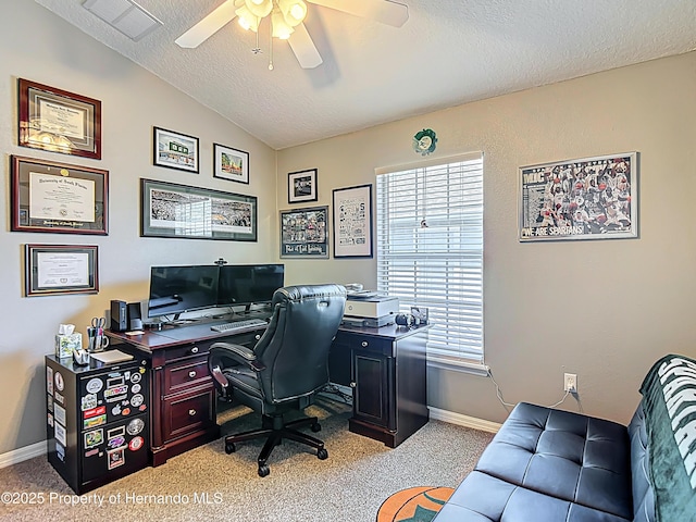 office area with a textured ceiling, light colored carpet, a ceiling fan, and visible vents