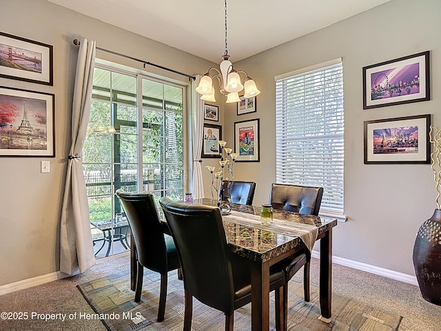 dining area featuring a notable chandelier, baseboards, and carpet floors