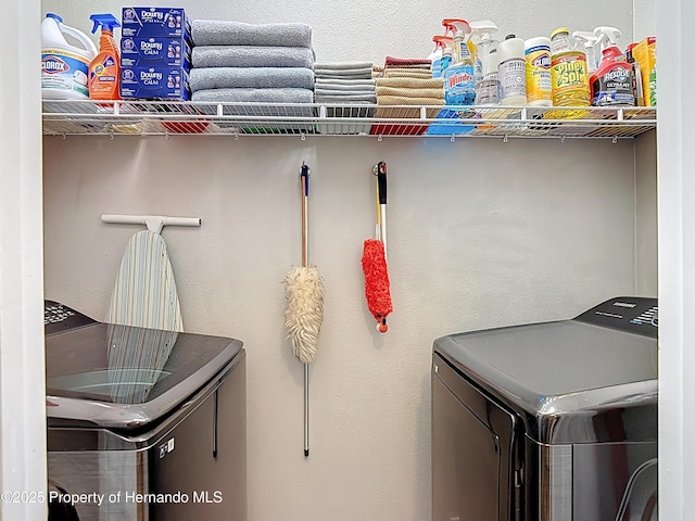 washroom featuring washer and clothes dryer and laundry area