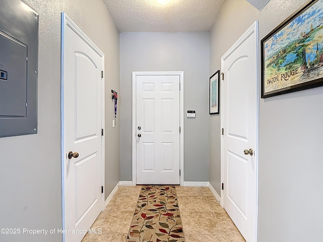 doorway to outside with a textured ceiling and electric panel