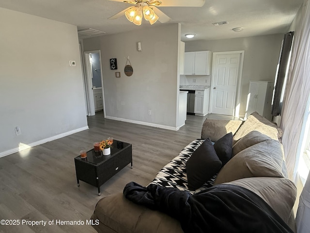 living area with wood finished floors, ceiling fan, baseboards, and visible vents