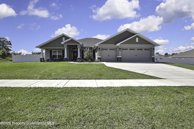 12848 Hilary St, Spring Hill, FL 34609 - craftsman house featuring driveway, fence, a garage, and a front lawn